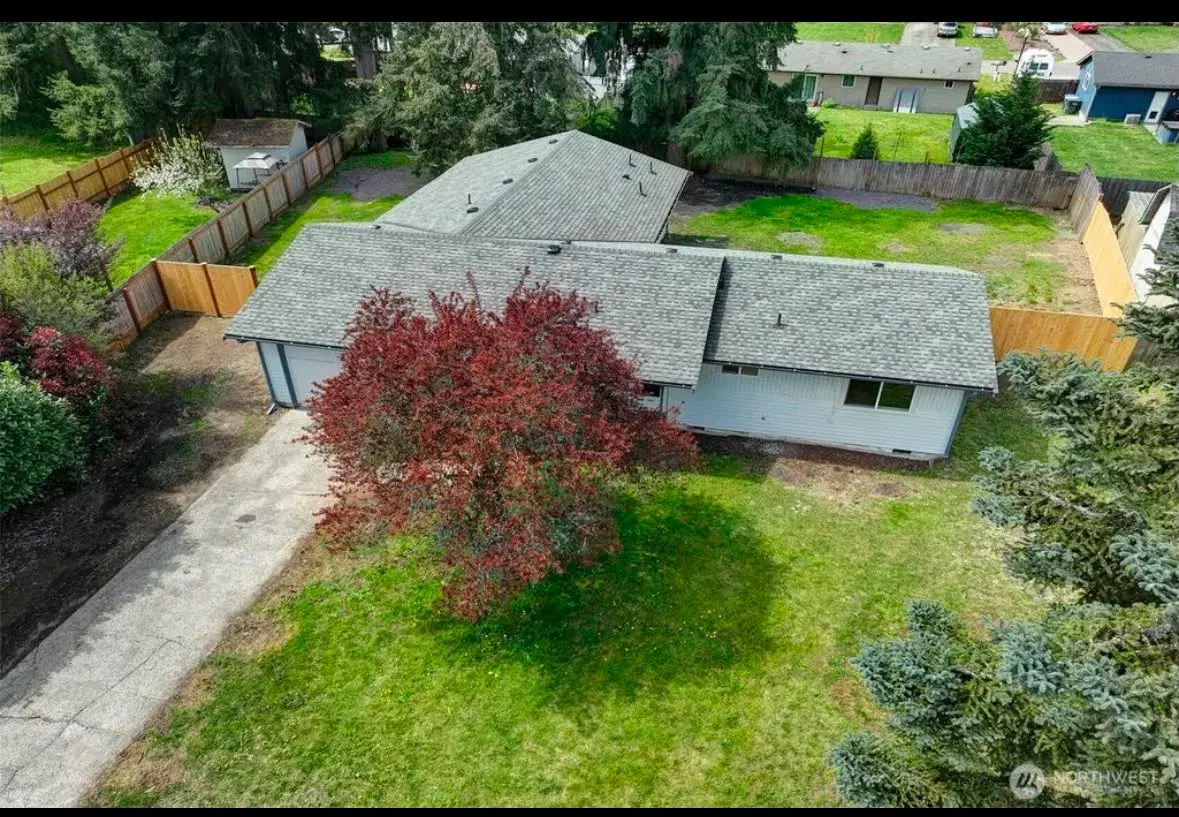 Aerial view of the home and fully fenced backyard