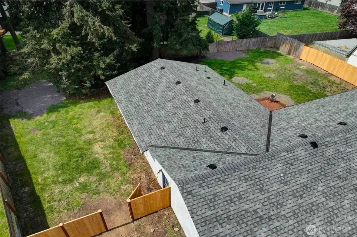 Overhead view of the home's roofline and backyard greenery