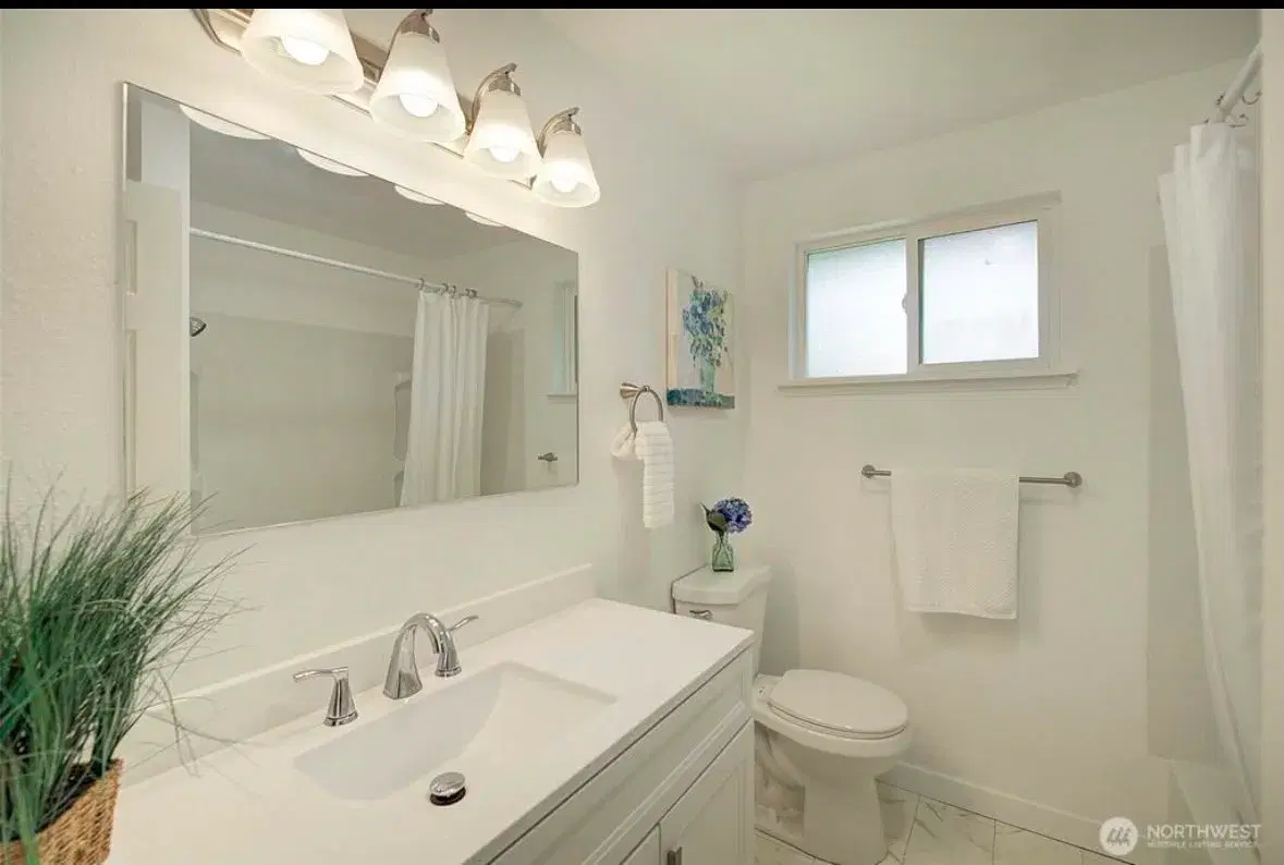 Clean, accessible bathroom with vanity and tub shower