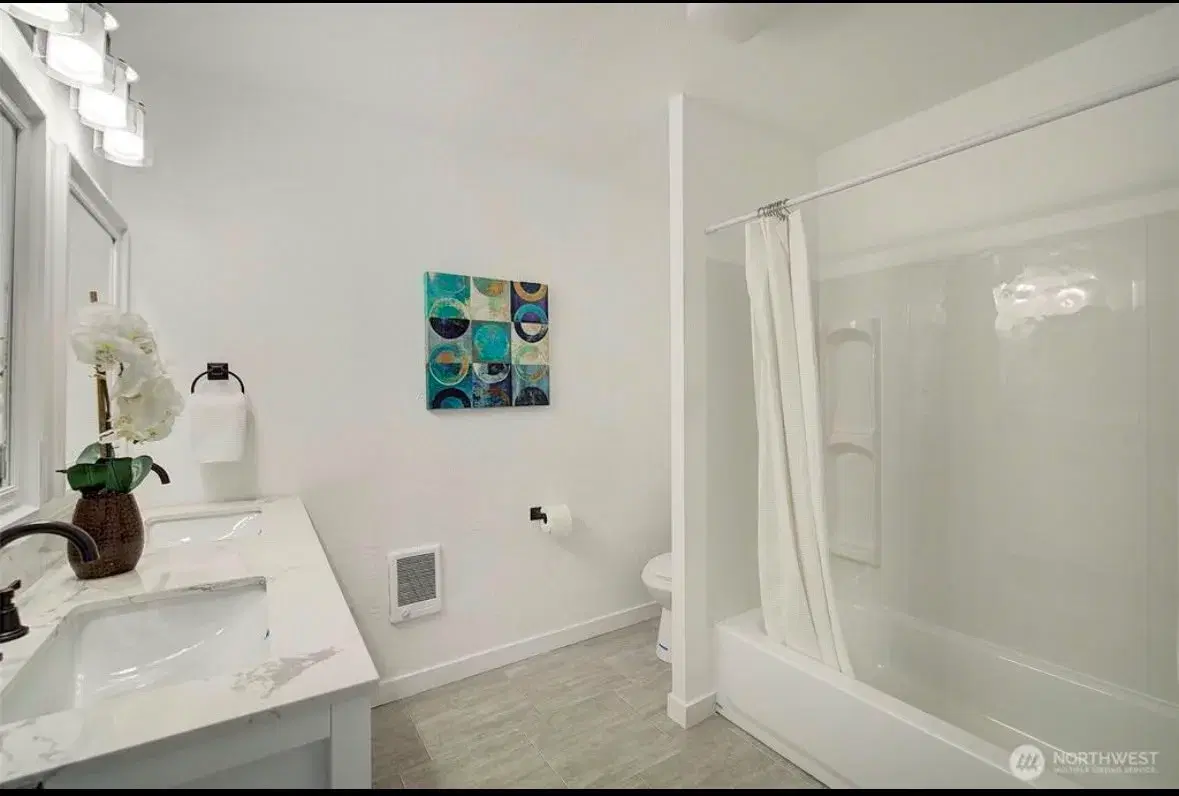 Bathroom with double vanity and walk-in tub shower