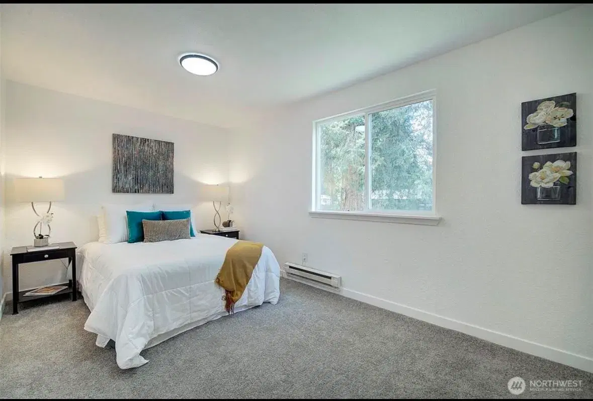 Comfortable resident bedroom with queen bed and natural light