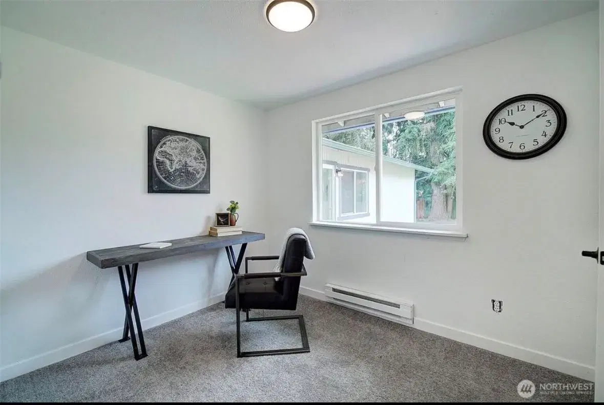 Quiet bedroom with desk area and backyard views