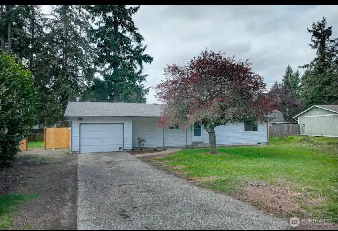 Front view of the home with driveway and attached garage