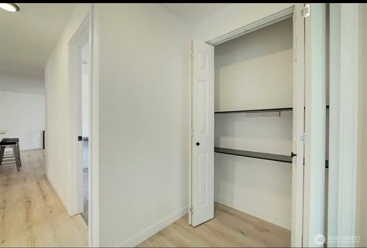 Hallway with linen storage and easy access between rooms