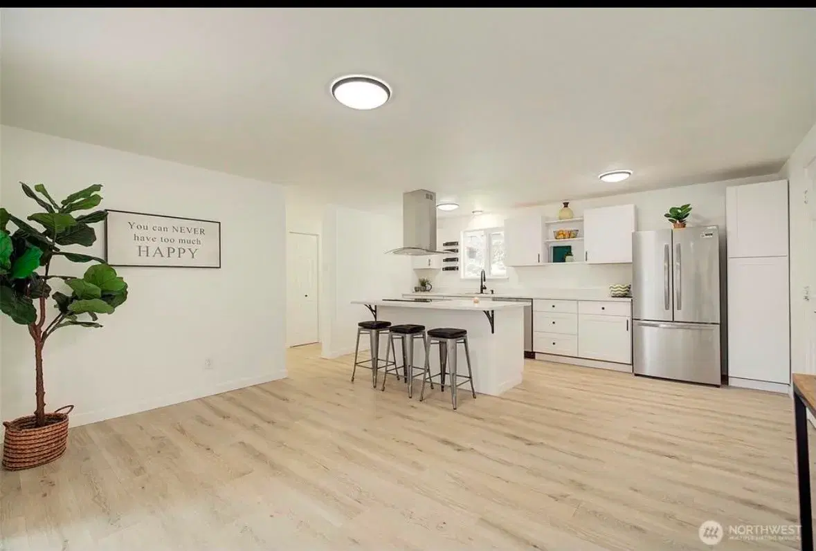 Open kitchen with island seating and modern appliances