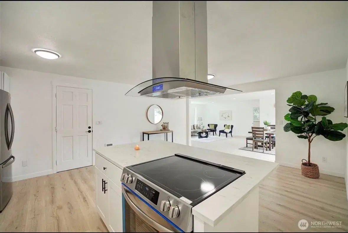 Kitchen island cooktop with modern range hood