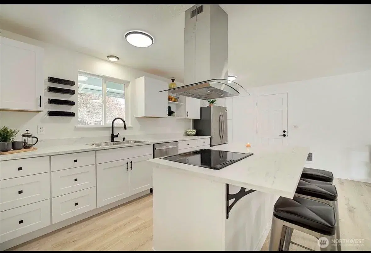 Bright white kitchen with ample cabinet and counter space