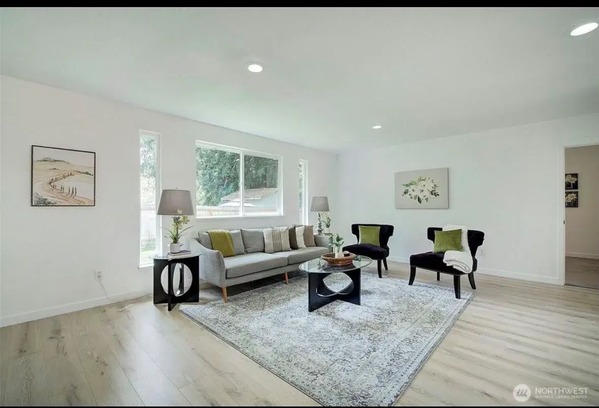 Spacious living room with large windows and natural light
